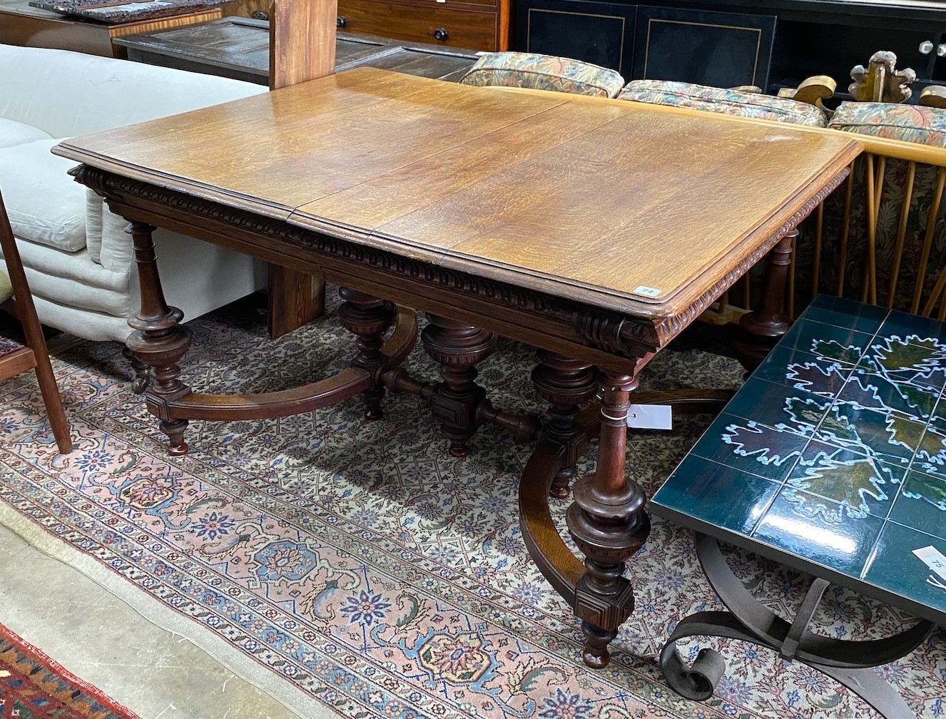 A late 19th / early 20th century French oak extending dining table, (one spare leaf) length 125cm, depth 99cm, height 77cm